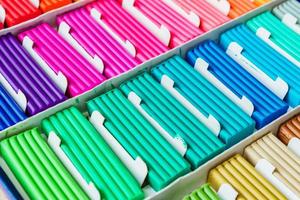 Rainbow colors of modeling clay. Multicolored plasticine bars ina box, background texture photo