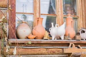 Different clay jars on wooden window sill. Interior decoration. Rustic style. photo