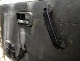 interior door panels in an old car in gray color and equipped with original manual handles and window adjusters photo