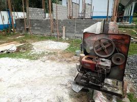 a concrete mixer installed on a construction site next to a pile of sand and gravel. photo