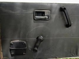 interior door panels in an old car in gray color and equipped with original manual handles and window adjusters photo