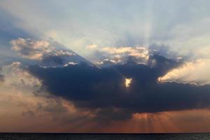 The sun sets below the horizon on the Mediterranean Sea in northern Israel. photo