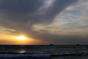 The sun sets below the horizon on the Mediterranean Sea in northern Israel. photo