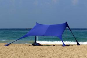 Tourist tent on the Mediterranean coast. photo