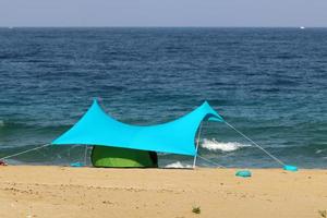 Tourist tent on the Mediterranean coast. photo