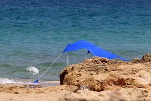 Tourist tent on the Mediterranean coast. photo