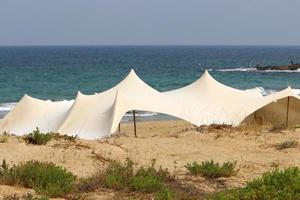 Tourist tent on the Mediterranean coast. photo