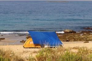 Tourist tent on the Mediterranean coast. photo