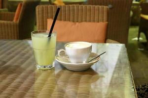 On the table in a glass of soft drinks. photo