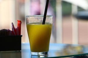 On the table in a glass of soft drinks. photo