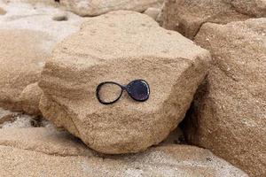 Old glasses are lying in the city park on the seashore. photo