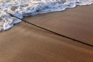 A rope with floats to secure a safe swimming area on the beach. photo