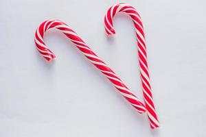 two candy canes on white background. Traditional Christmas candies. photo