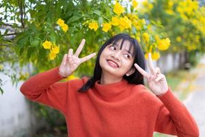 Portrait young girl with yellow flowers, Asian girl. photo