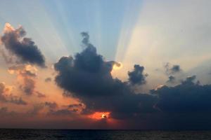 The sun sets below the horizon on the Mediterranean Sea in northern Israel. photo