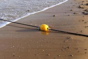 A rope with floats to secure a safe swimming area on the beach. photo