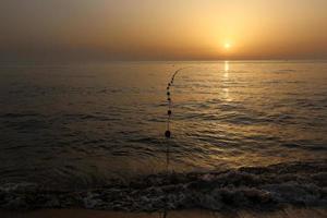 The sun sets below the horizon on the Mediterranean Sea in northern Israel. photo