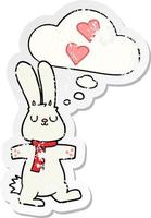 cartoon rabbit in love and thought bubble as a distressed worn sticker vector