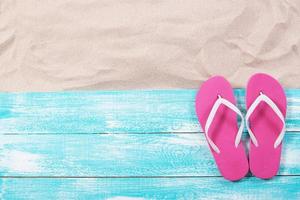 Summer background, summer items on the sand top view - copy space photo