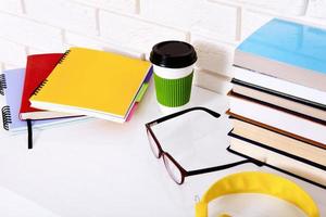 Workplace and education accessories on white table. Selective focus and copy space. Business school concept photo