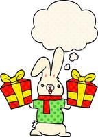 cartoon rabbit with christmas presents and thought bubble in comic book style vector