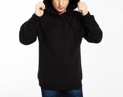Casual image of caucasian male wearing a black hoodie, photographed in studio. Black sweatshirt mockup photo