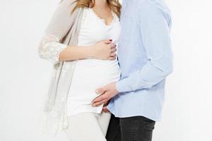 cropped image beautiful young couple expecting baby standing together and touching belly isolated on white background photo