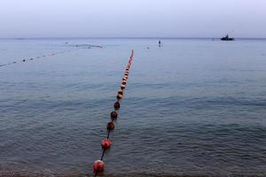 A rope with floats to secure a safe swimming area on the beach. photo