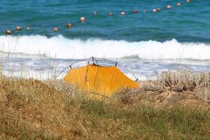 Tourist tent on the Mediterranean coast. photo