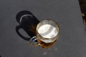 On the table in the restaurant a glass of fresh and cold beer. photo