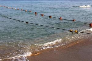 A rope with floats to secure a safe swimming area on the beach. photo