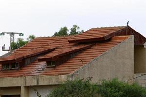 Karmiel Israel August 20, 2021. Red tiled roof of a residential building photo