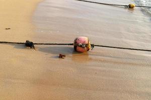 A rope with floats to secure a safe swimming area on the beach. photo