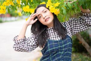 Portrait young girl with yellow flowers, Asian girl. photo