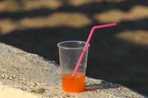 On the table in a glass of soft drinks. photo