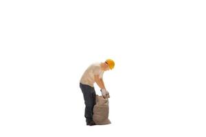 Miniature  worker isolated on white background with clipping path photo