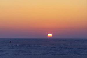 Natural backdrop with sunset over the frozen sea photo