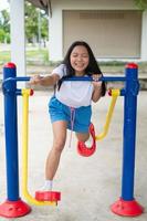 Young girl doing exercise with colorful equipment exercise. photo