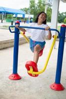 Young girl doing exercise with colorful equipment exercise. photo