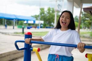 Young girl doing exercise with colorful equipment exercise. photo