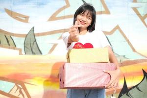 Happy young girl with gift box. photo
