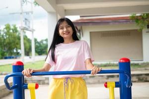 Young girl doing exercise with colorful equipment exercise. photo