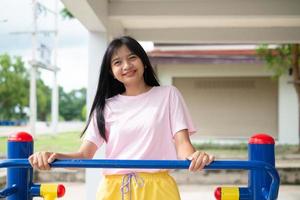 Young girl doing exercise with colorful equipment exercise. photo