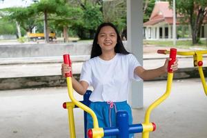 Young girl doing exercise with colorful equipment exercise. photo