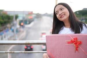 Happy young girl with gift box. photo