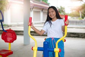 Young girl doing exercise with colorful equipment exercise. photo
