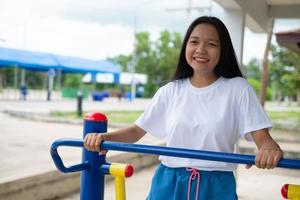 Young girl doing exercise with colorful equipment exercise. photo