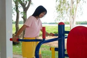 Young girl doing exercise with colorful equipment exercise. photo