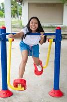 Young girl doing exercise with colorful equipment exercise. photo