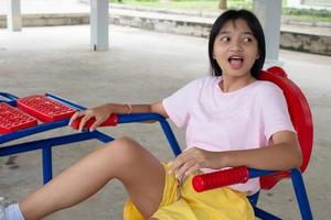 Young girl doing exercise with colorful equipment exercise. photo